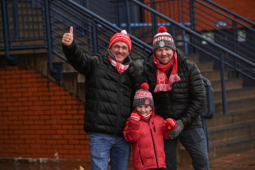 Dons fans with Aberdeen hats and scarves.