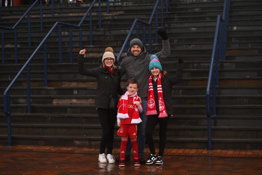Family of Aberdeen supporters cheering at Hampden.