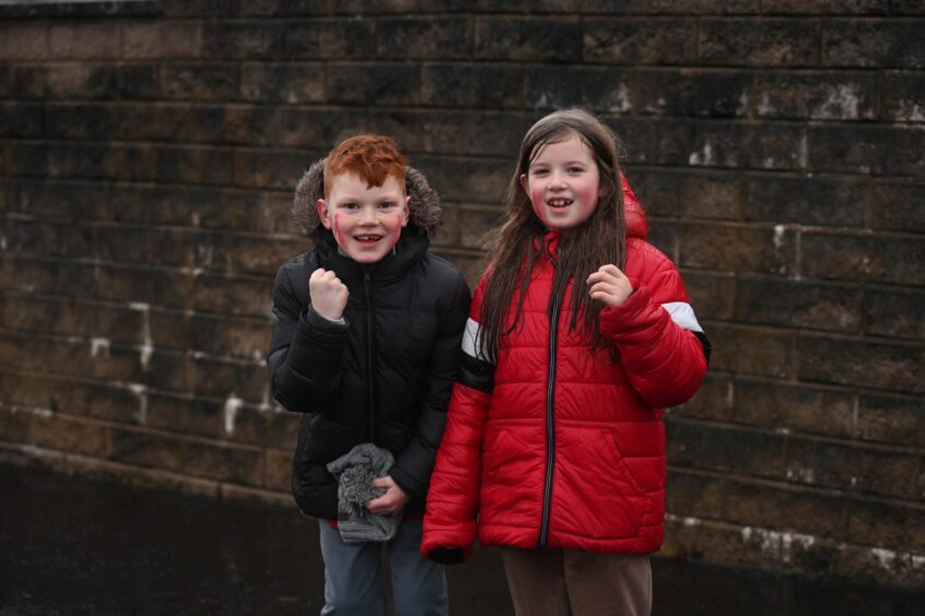 Two young Dons fans cheer ahead of the game.