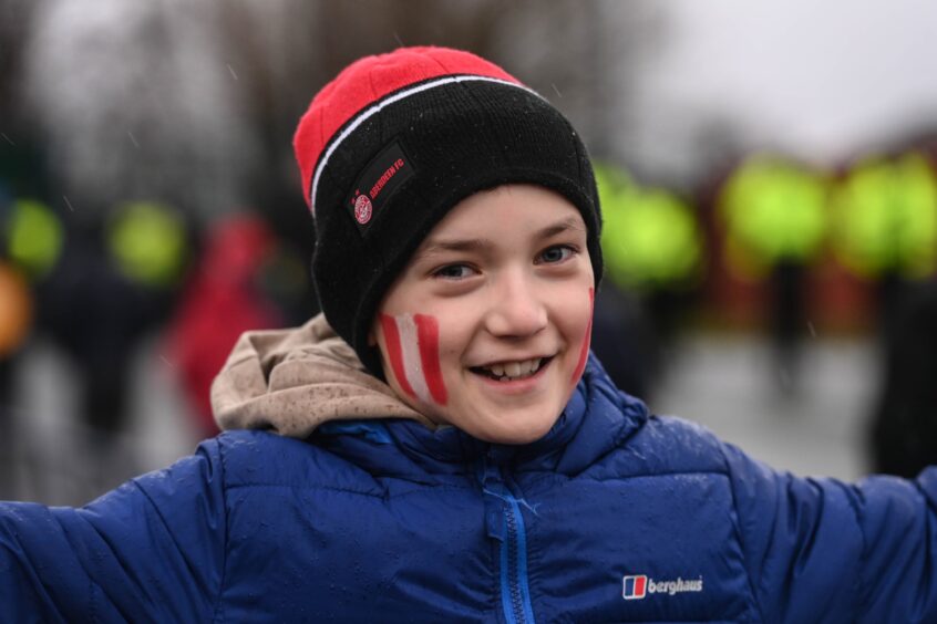 Young Dons fan with red and white face paint.