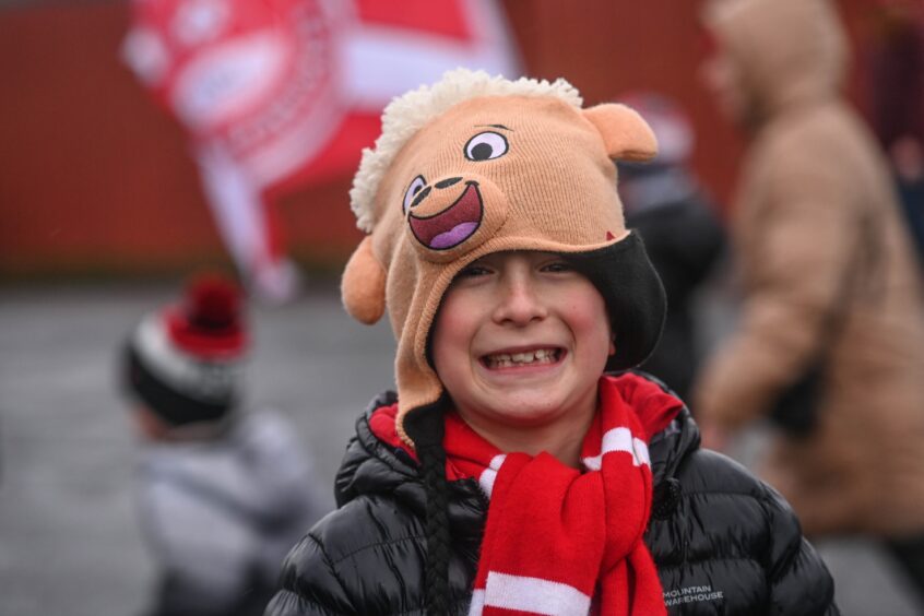 Youngster wears mascot hat in support for the Dons.