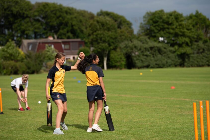 Students playing sport on a field at Robert Gordon's College.