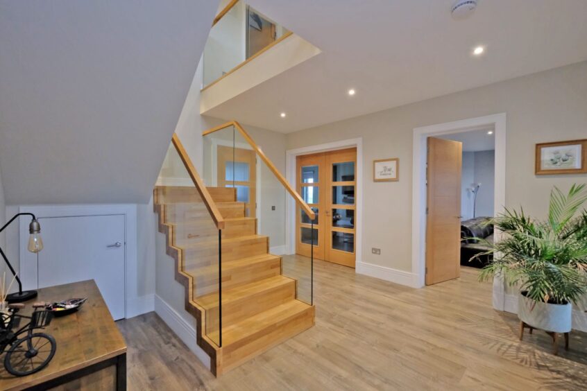 The hallway and staircase in the Newburgh modern home