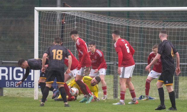 Deveronvale, in red, battle to stop Clachnacuddin from scoring in the Breedon Highland League clash at Princess Royal Park. Pictures by Jasperimage