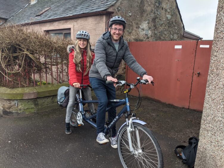 Katie and her boyfriend on a tandem bike