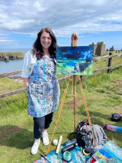 Artist Rebecca Patterson with her painting of Dunnottar