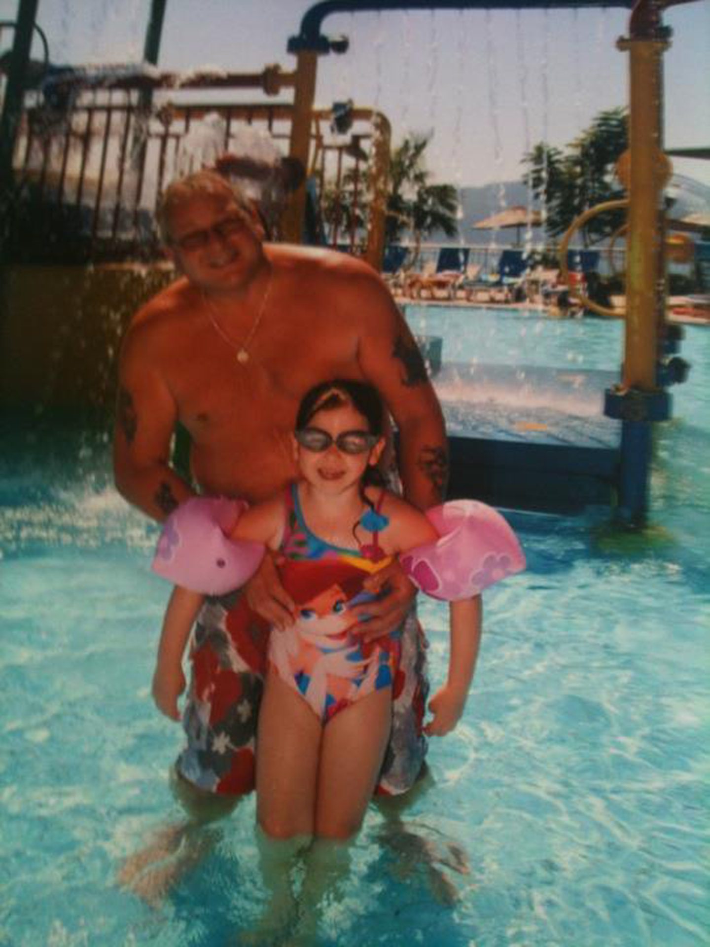 A holiday snap of Tommy in a pool with a grandchild.