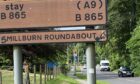 The Millburn roundabout sign has been looking a little worse for wear for many years. Image: DC Thomson