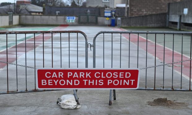Gates across car park with sign saying "car park closed beyond this point".