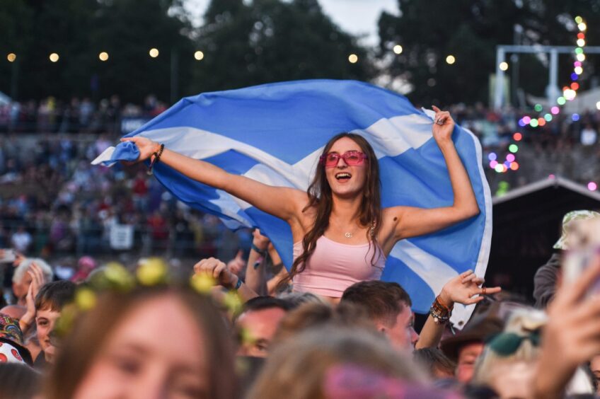 An excited fan waves her saltire. Supplied by Paul Campbell.