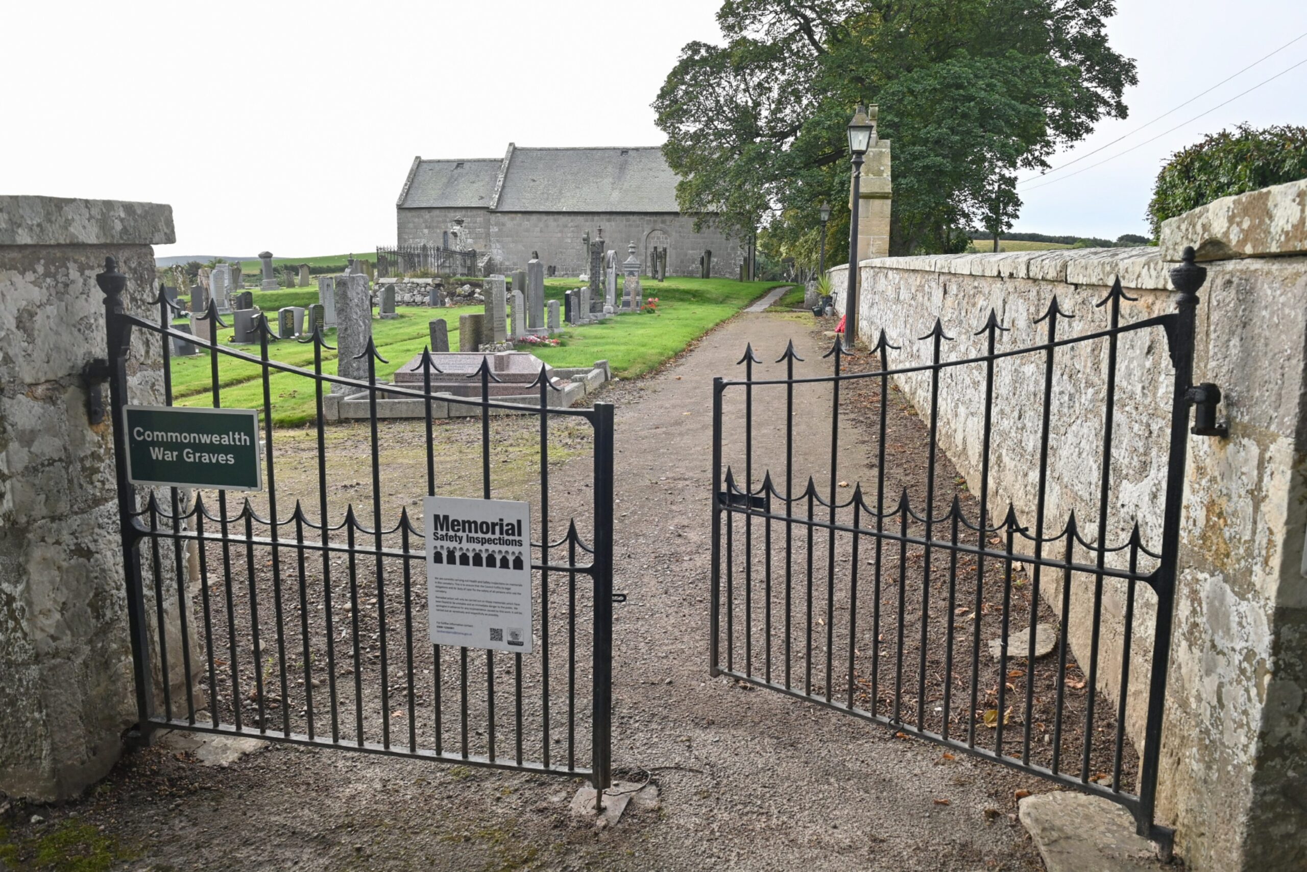 Birnie Kirk gates leading to graveyard with one slightly ajar. 