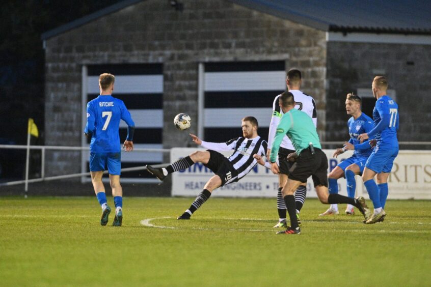 Elgin City's Robert Jones attempts a bicycle kick in a League Two match against Peterhead at Borough Briggs.