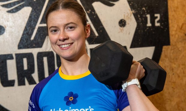 Aine Gillespie holds a dumbell in the CrossFit Aberdeen gym.