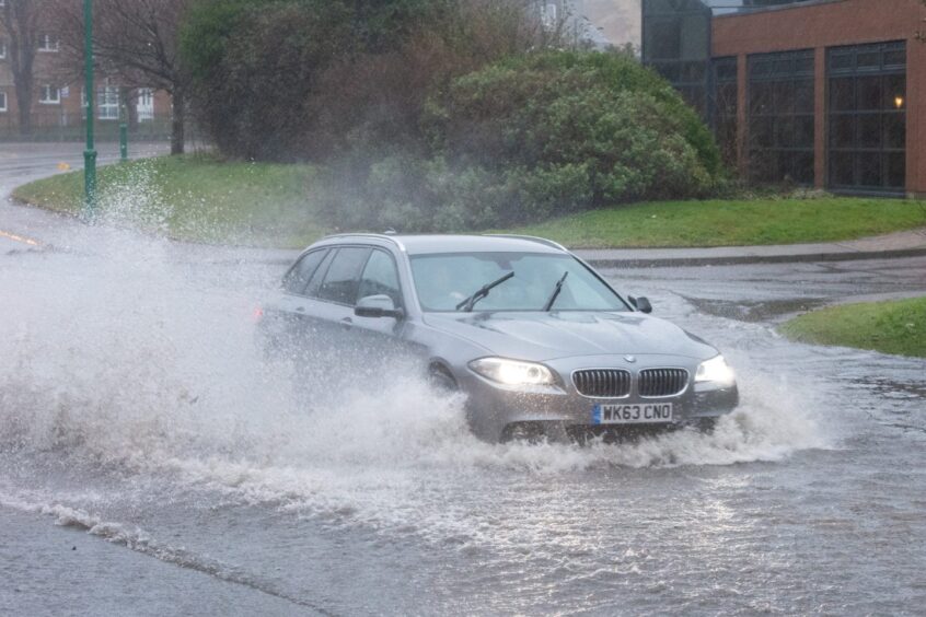 Car driving through flooded road in Aberdeen