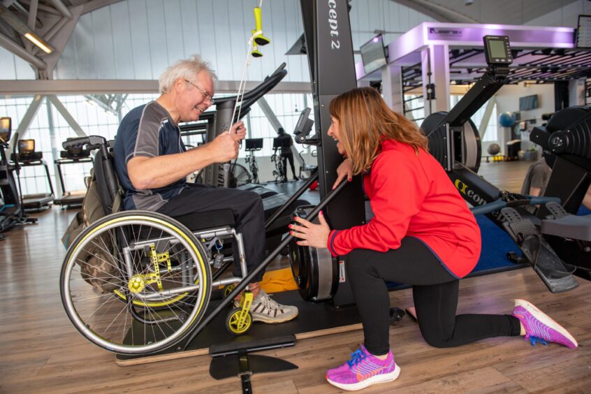 Tracy Stainer working with amputee Bernie van der Heijdt at a gym class in Aberdeen Sports Village