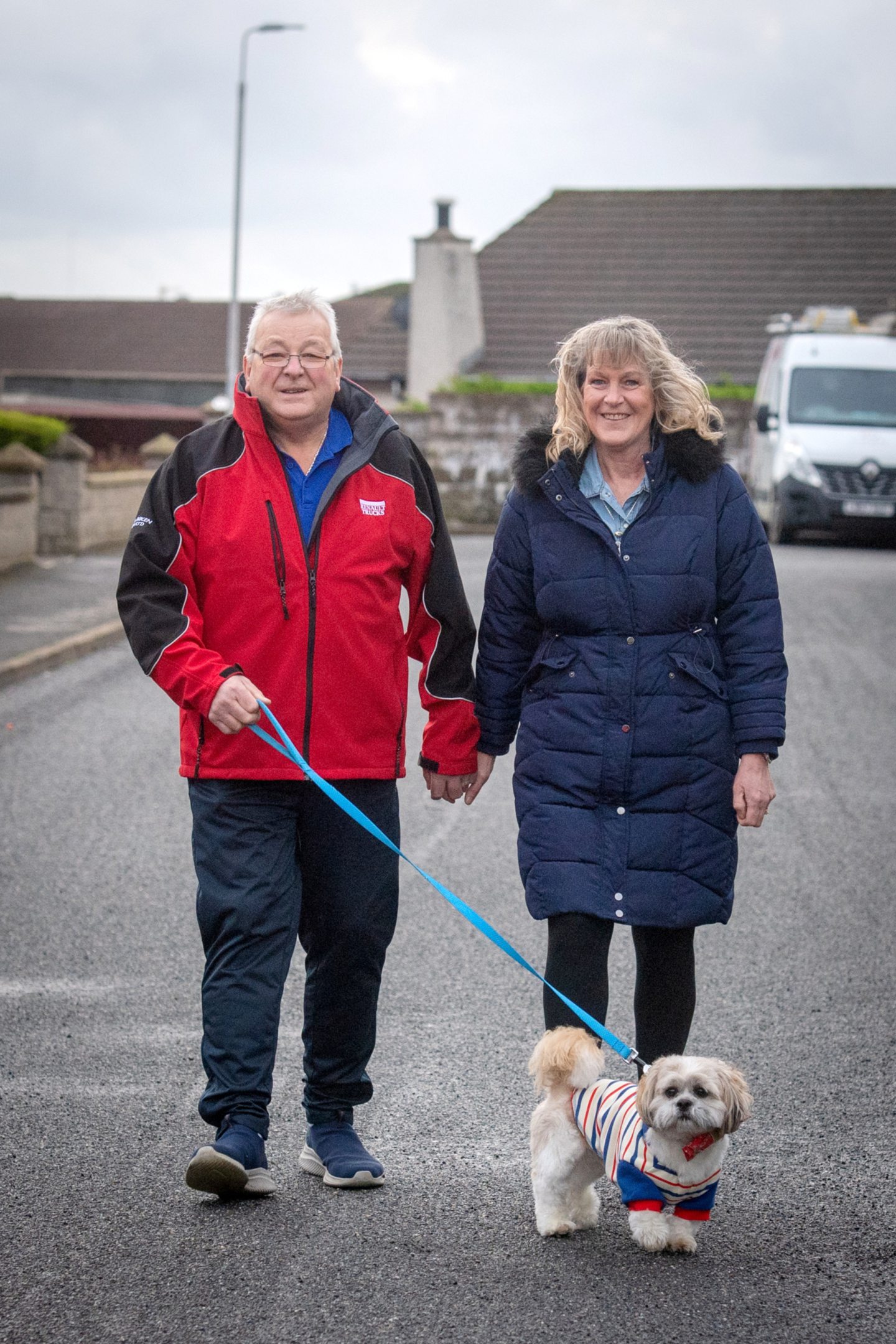 Tommy and Margaret walking down a street Fraserburgh taking dog Teddy for a walk.