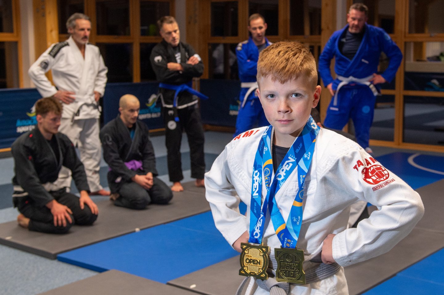 Dexter Richardson with his two medals in front of the BJJ class.