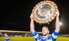 Banks o' Dee captain Kane Winton with the Aberdeenshire Shield. 
Image: Kami Thomson/DC Thomson.