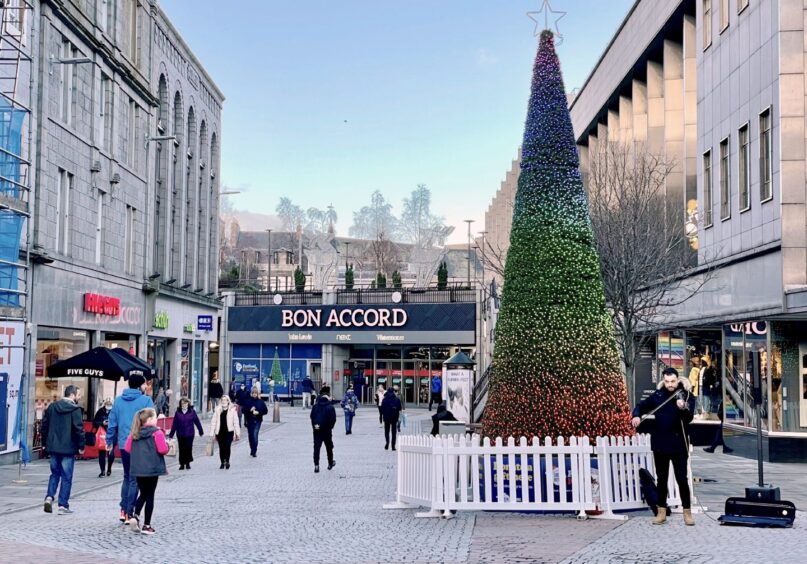 Shoppers and Christmas tree outside the Bon Accord Centre 