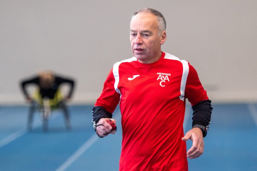 Aberdeen Amateur Athletic Club coach Phil Owens at Aberdeen Sports Village's indoor athletics track working with his star athlete, wheelchair ace Joanna Robertson. Image: Kami Thomson/DC Thomson.