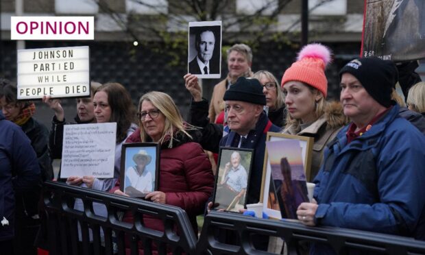 Protesters wait outside the UK Covid-19 Inquiry at Dorland House in London, where the former prime minister Boris Johnson has been giving evidence. Image: Jonathan Brady/PA Wire