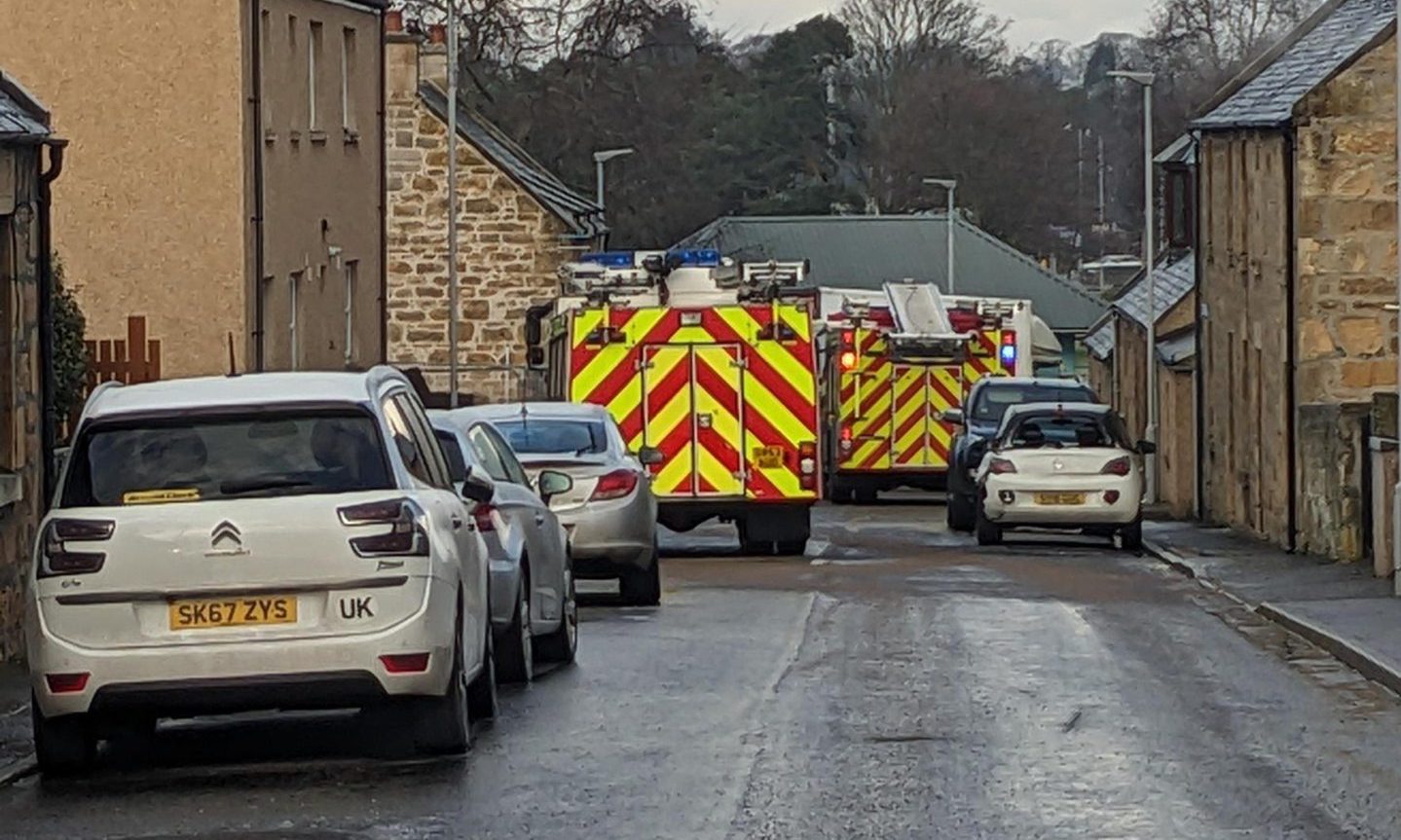 Fire engines block a residential street in New Elgin following a crash.