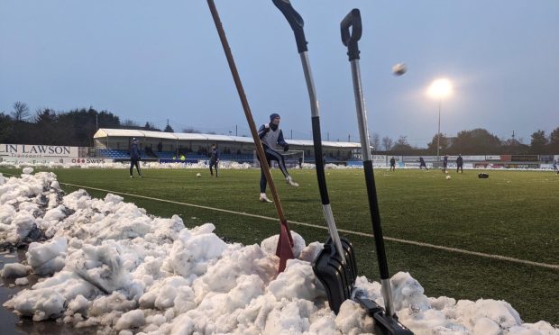 Snow had to be cleared off the pitch  at the Balmoral Stadium ahead of Cove's matcha gainst Edinburgh City. 
Image: Kath Flannery/DC Thomson.