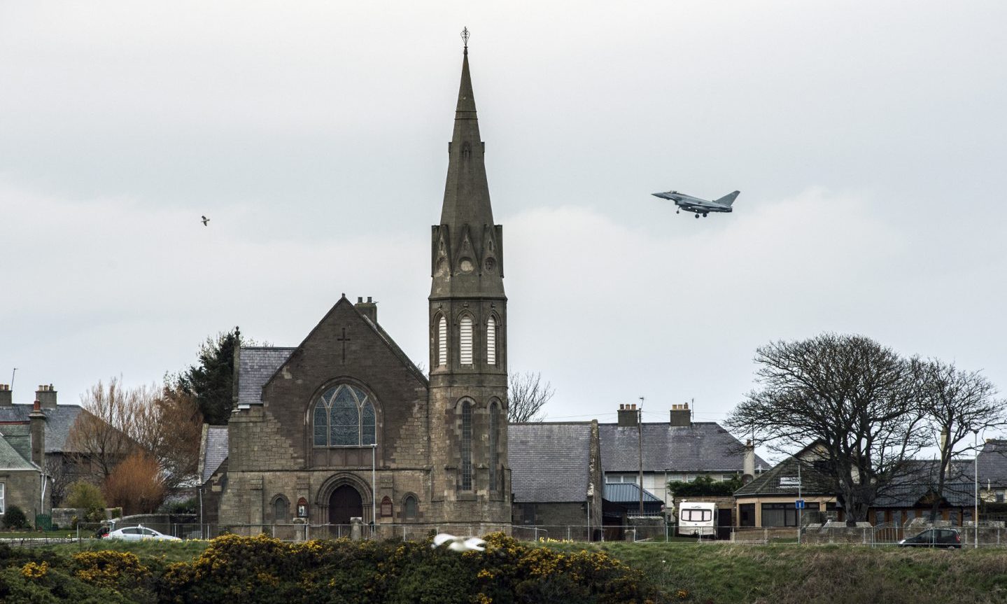 Skyline of Lossiemouth with church and RAF Typhoon behind. 