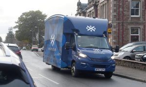A blue Bank of Scotland mobile bank drives through Beauly.