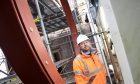 Principal project manager Jason Kelman with the steel frame for the feature rose window. Image Sandy McCook/DC Thomson