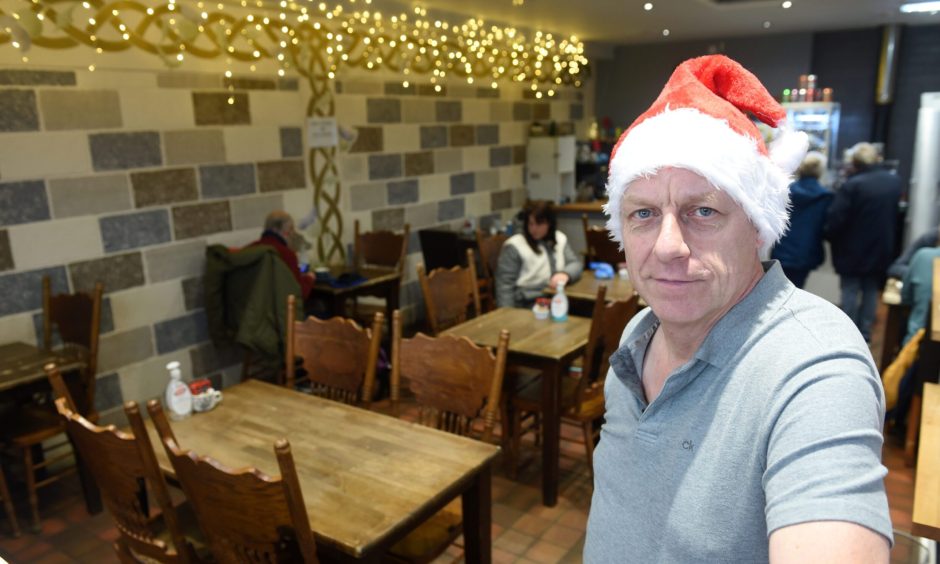 Peter Nairn in Jammy Piece cafe Inverness wearing a santa hat