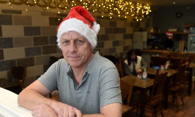 Peter Nairn in the cafe with a santa hat on