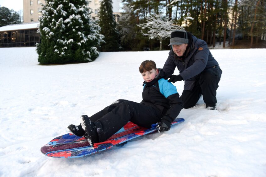 Jensen Blatston needs a push from his father Lee in the snow on Boxing Day in the Cairngorms.