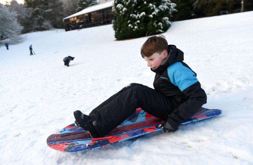 Jensen Blatston needs a push from his father Lee in the snow on Boxing Day in the Cairngorms.