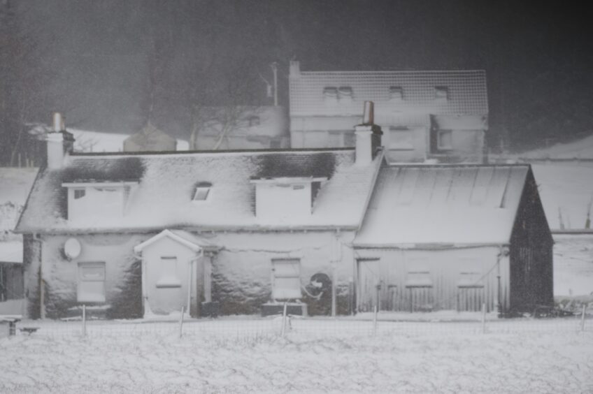 Homes near Dalwhinnie covered in snow.