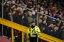 A police officer guarding fans at Pittodrie. Image: Andrew Milligan/PA Wire