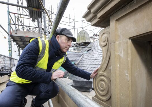 Stephen Rankin, Director of Prestige with the stonework landscape on the building.