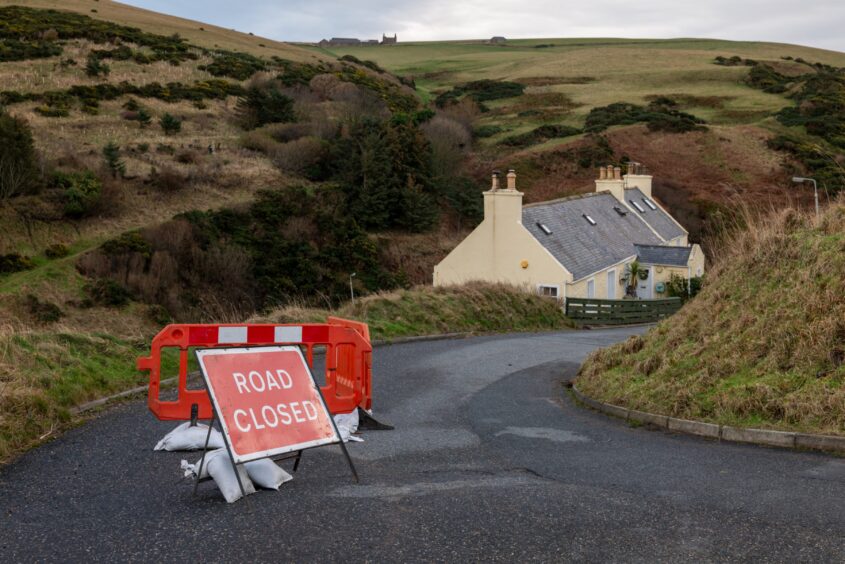 Road closed sign at road into Pennan, Aberdeenshire, after landslip caused by Storm Gerrit.