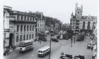 1949: The Castlegate with the narrow entrance to Lodge Walk and the police station on the left. The Salvation Army Citadel dominates the eastern end of Union Street, but the biggest change is the loss of the trams and their tracks. Image: DC Thomson