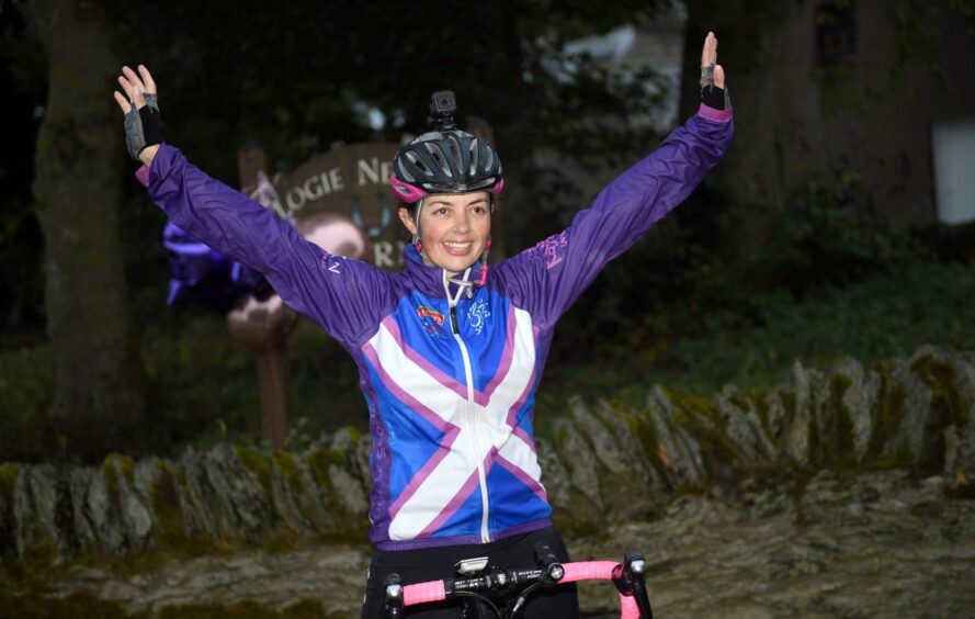 Louise pictured after completing her Tour O' Scotland cycling effort, arriving back at the family farm.