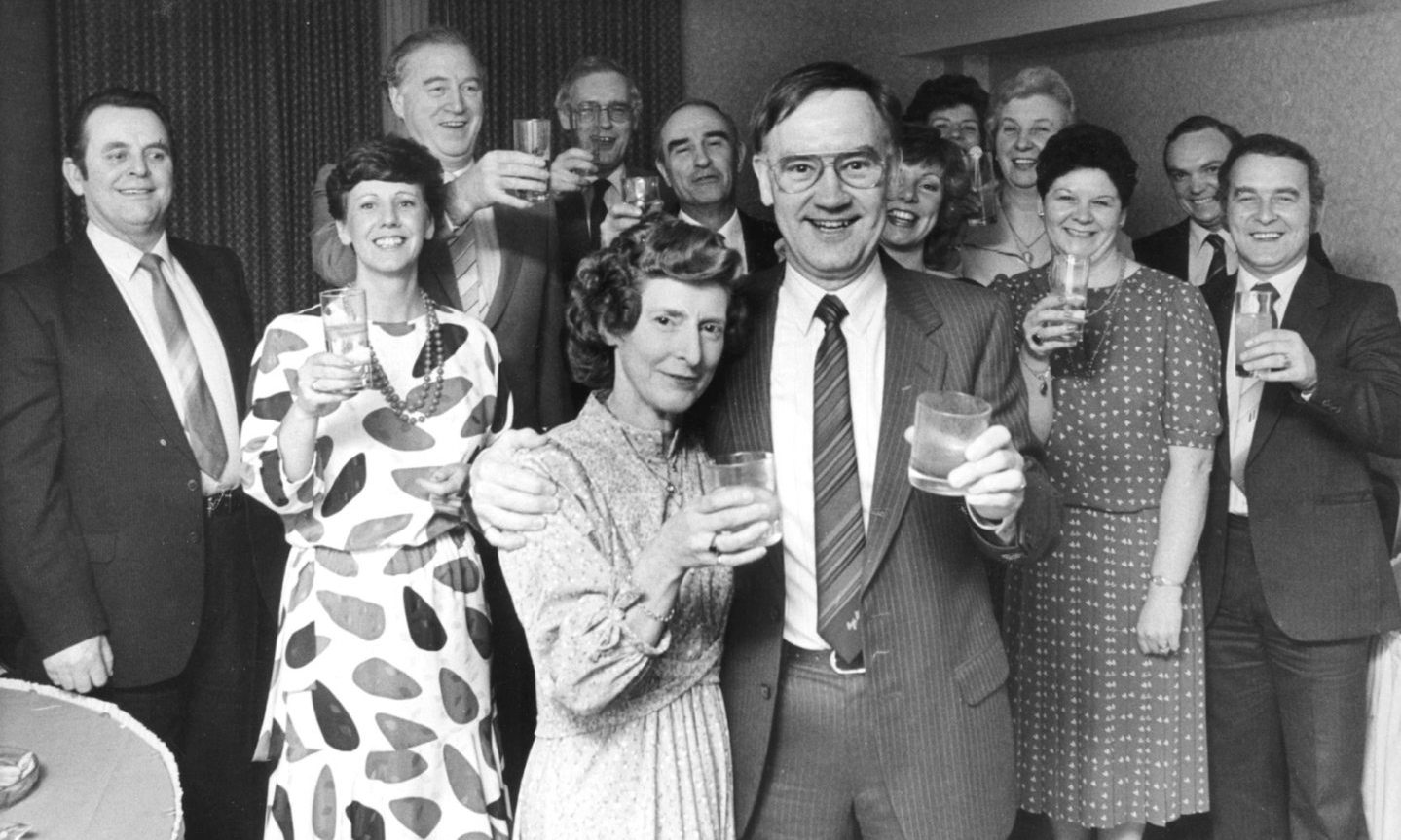 Marks and Spencer warehouse manager Douglas Melvin and his wife Rose holding drinks in front of a large group of people