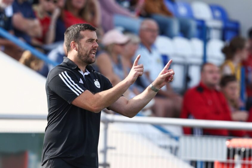 Aberdeen FC Women manager Clint Lancaster demonstrates tactics from the sidelines in a SWPL match at Balmoral Stadium.