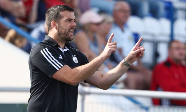 Aberdeen FC Women manager Clint Lancaster demonstrates tactics from the sidelines in a SWPL match at Balmoral Stadium.