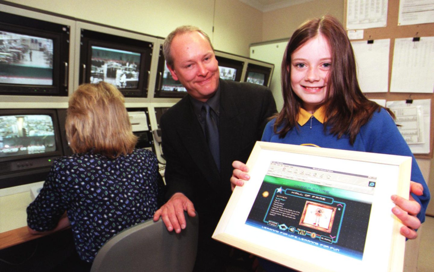 Kemnay Primary pupil Rachael Rodger shows her winning website page to Marks and Spencer dep store manager Richard Gilbert