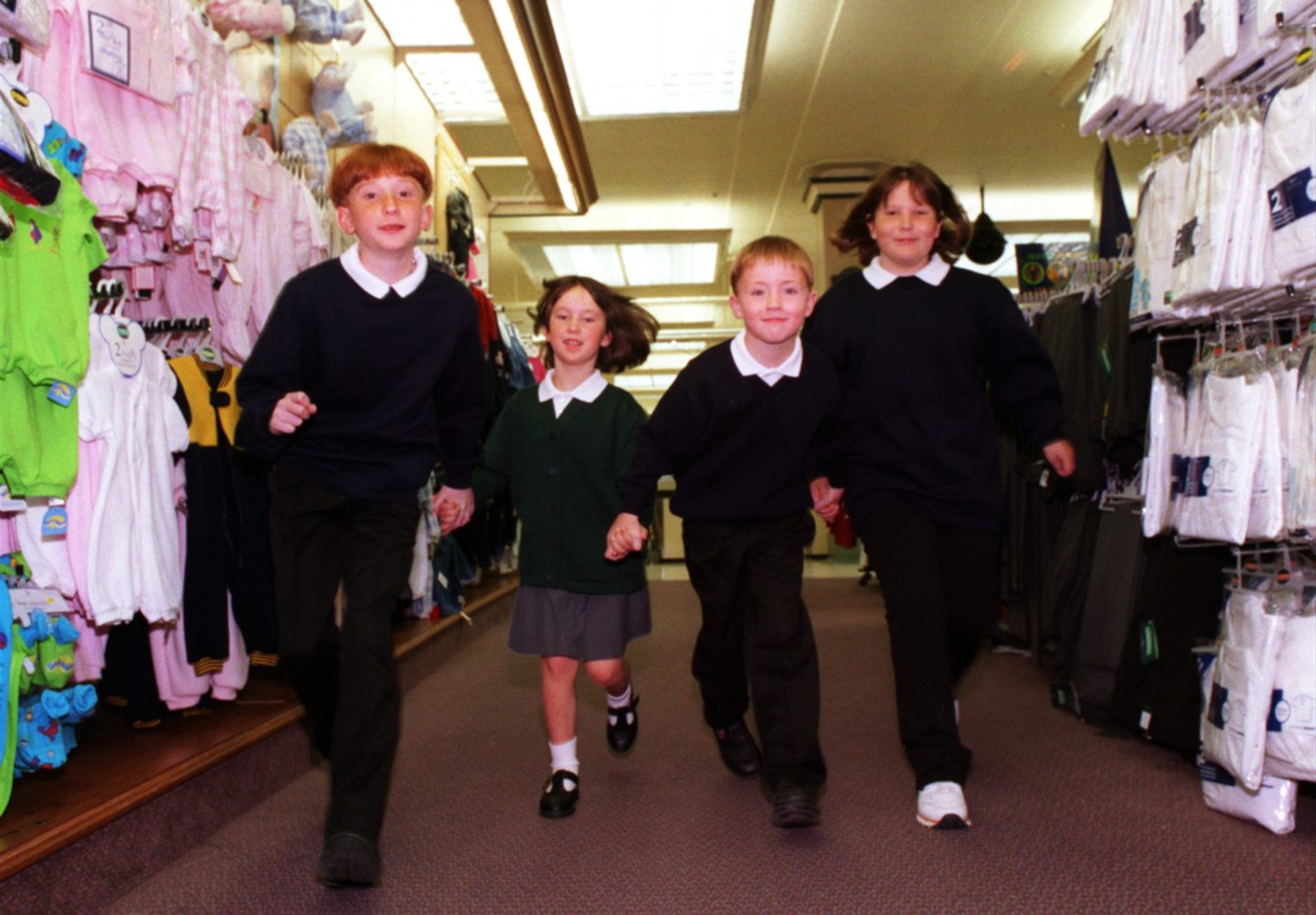 Four school pupils walking through M&S in Aberdeen
