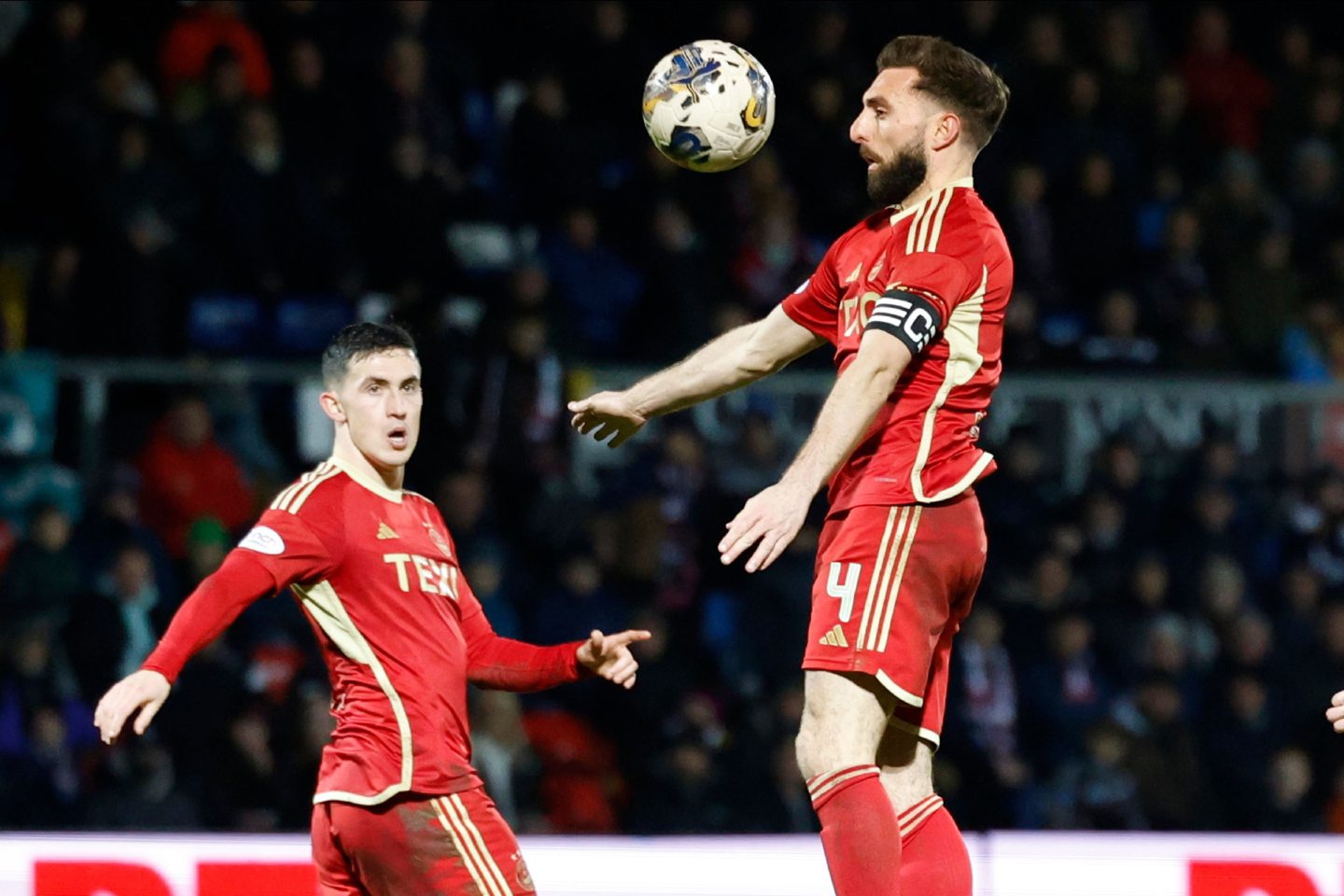 Aberdeen captain Graeme Shinnie jumps to head the ball in the 3-0 defeat of Ross County in Dingwall. Image: Shutterstock