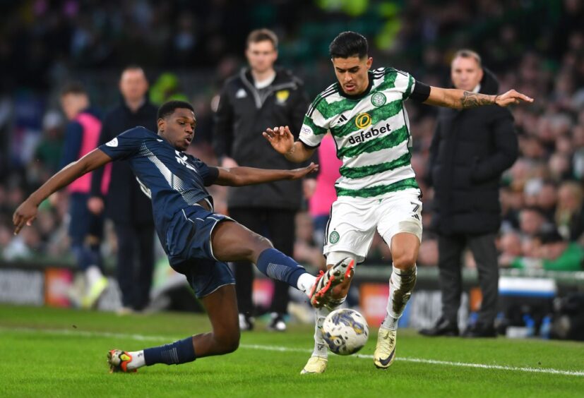 Loick Ayina in action for Ross County against Celtic.