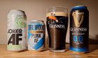 Alcohol free beers in cans, featuring Punk AF, Joker AF and Guinness 0,0, with the Guinness poured out into a glass.