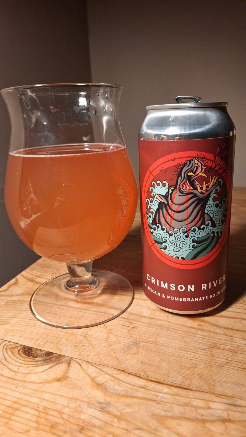 The can of Crimson River beer from Otherworld Brewing poured into a glass. 