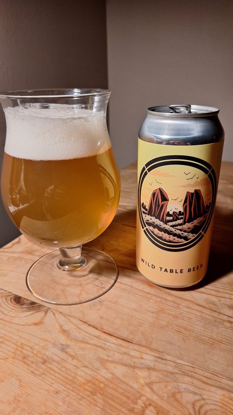 The can of Wild Table Beer from Otherworld Brewing poured into a glass. 